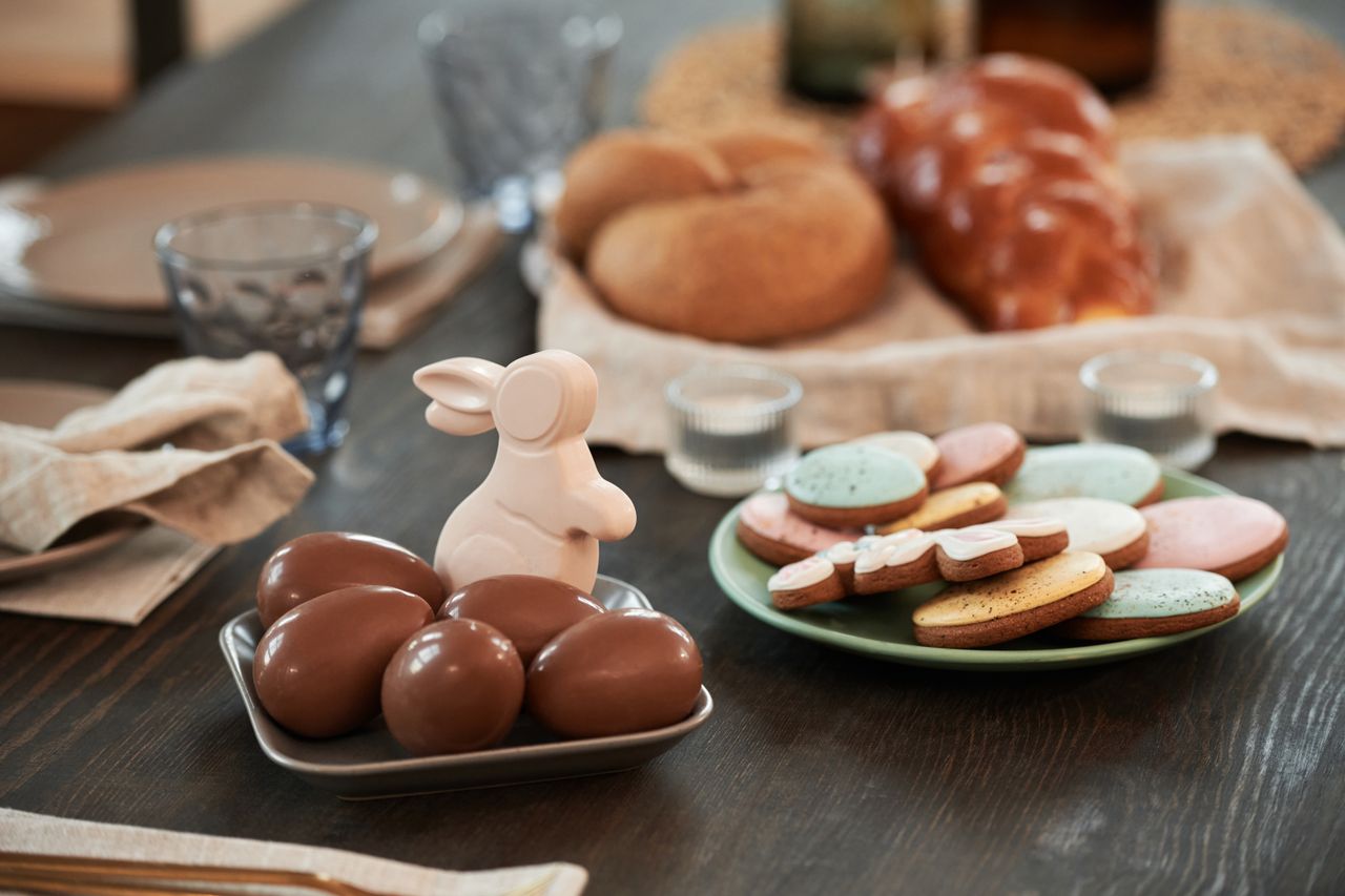 festive table setting with easter chocolate eggs and decorative cookie