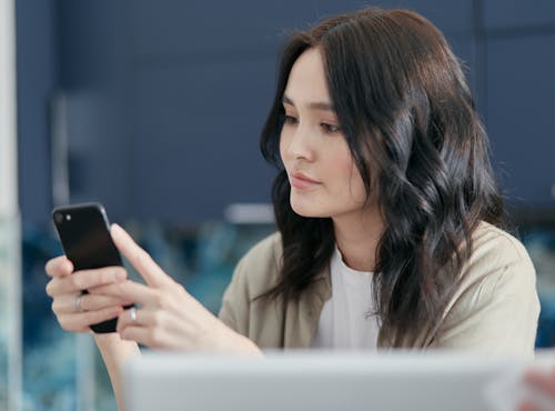 A Woman Holding Black Smartphone