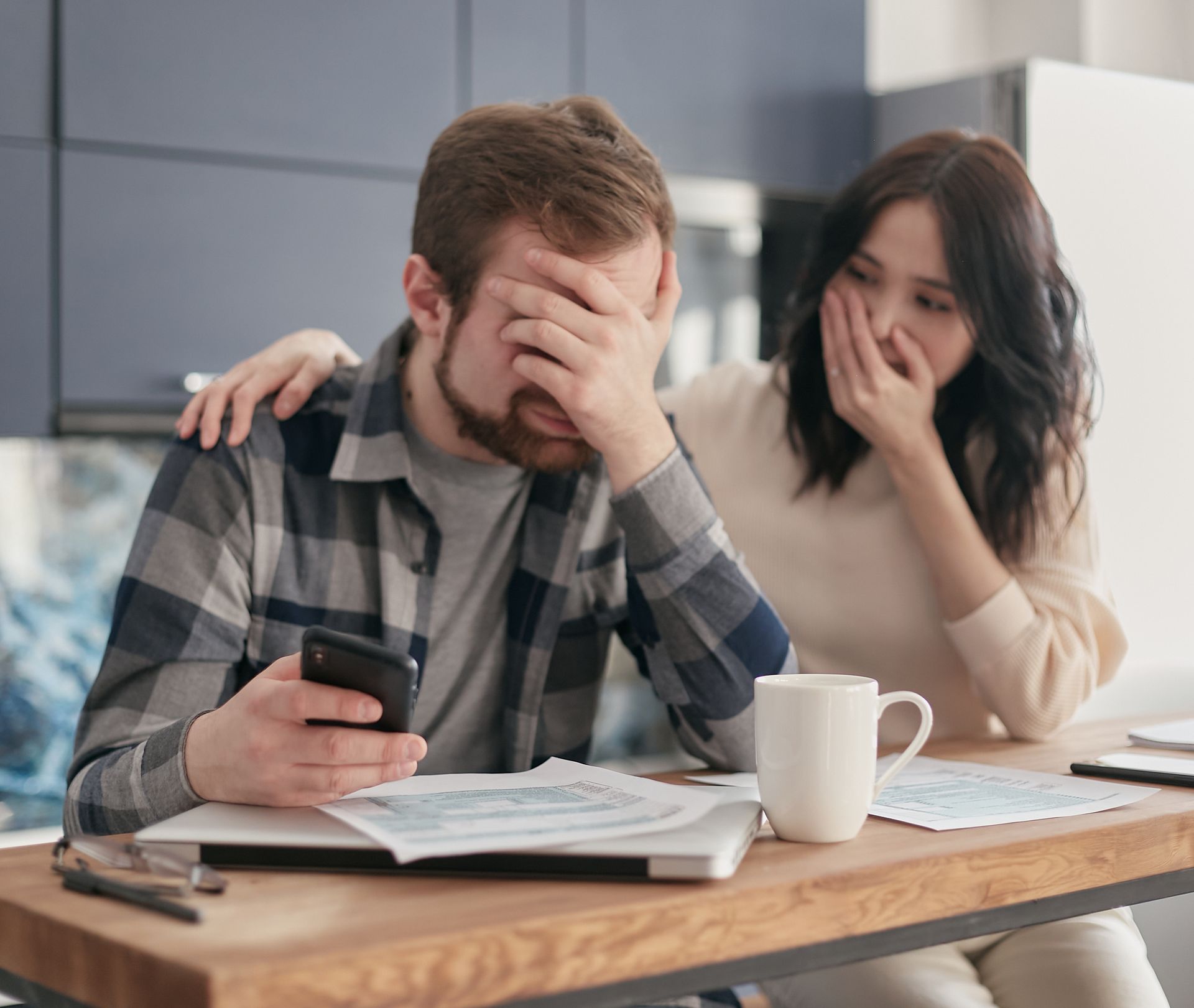 A Man Covering His Face in Frustration