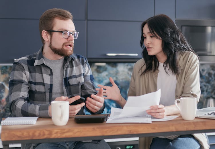 A Man And A Woman Having A Business Discussion