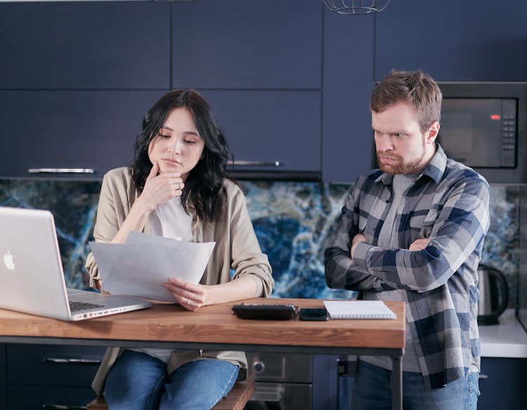 A Couple Looking A Documents