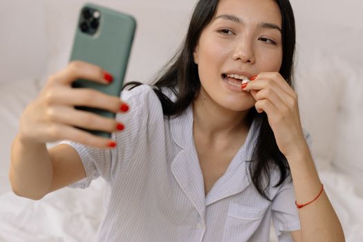 Woman in White Dress Shirt Holding Her Lips