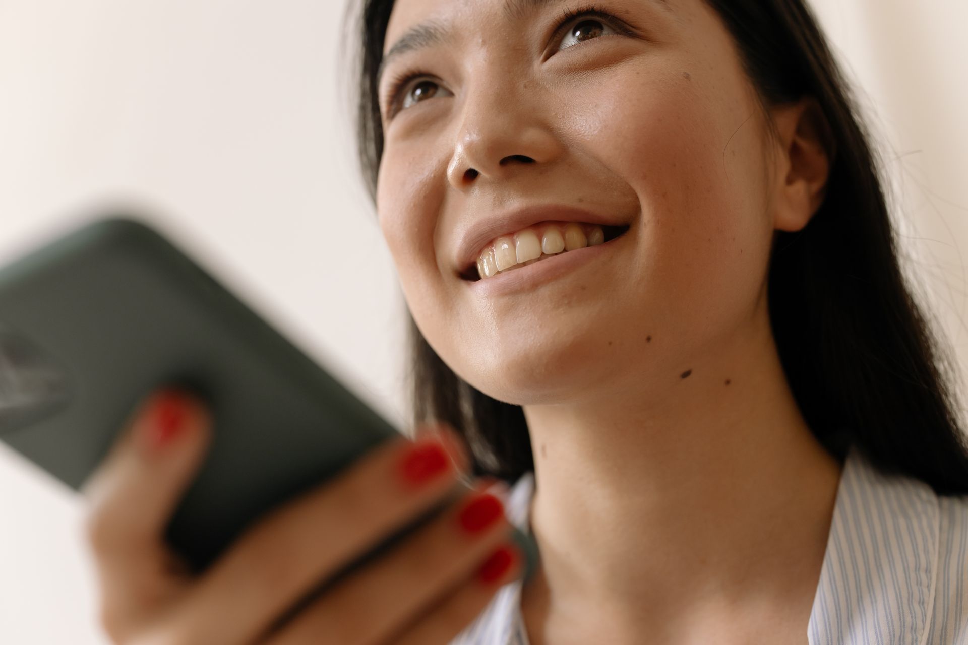Low Angle Shot of a Woman Holding a Smartphone