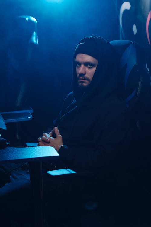 A Man in a Hoodie Sitting on a Chair