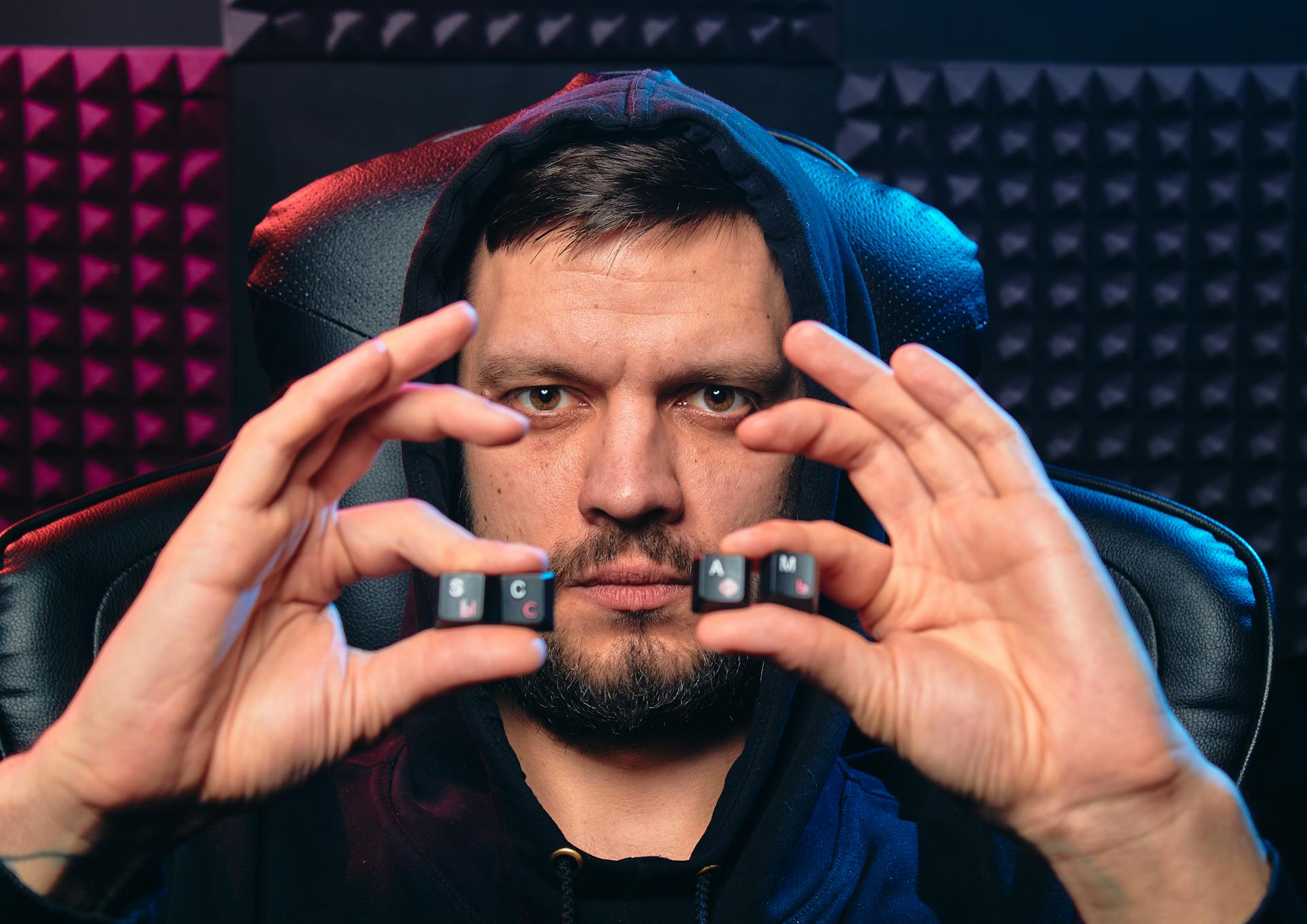 A Man Holding Alphabet Keys of Computer Keyboard