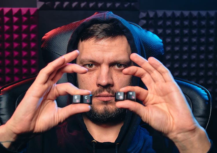 A Man Holding Alphabet Keys Of Computer Keyboard