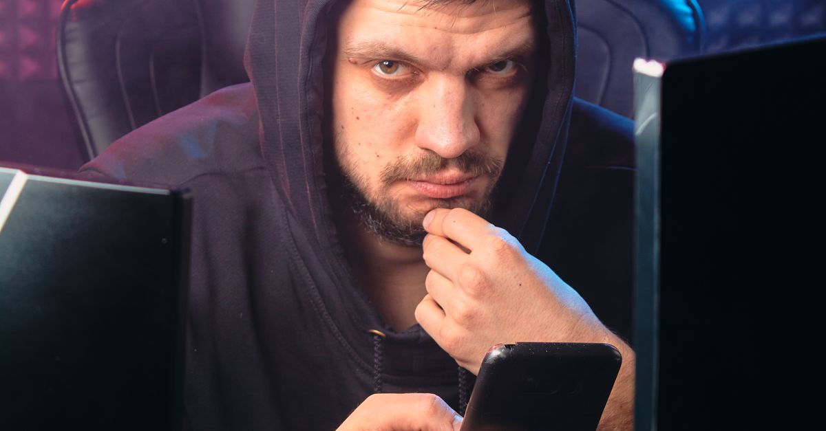Photo by Mikhail Nilov A man in a hoodie using a smartphone, representing cybersecurity themes.