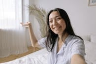 Smiling Woman in White Button Up Shirt