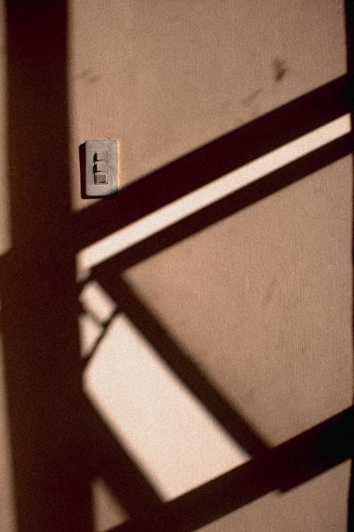 Wall with light switch in sunlight