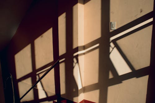 Passage of building with shadows from railings