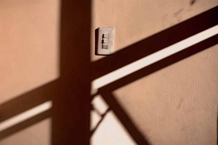 Shadow On Wall Of Building With Switch