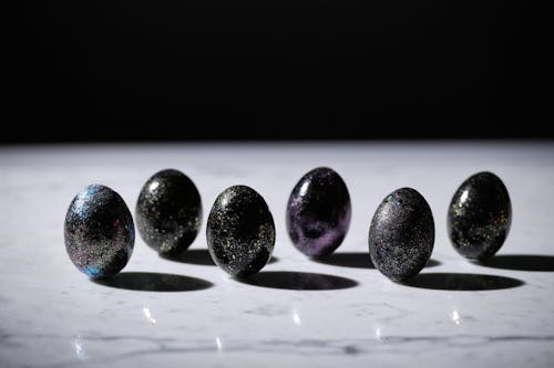 Free Black Glittery Eggs on Marble Surface Stock Photo