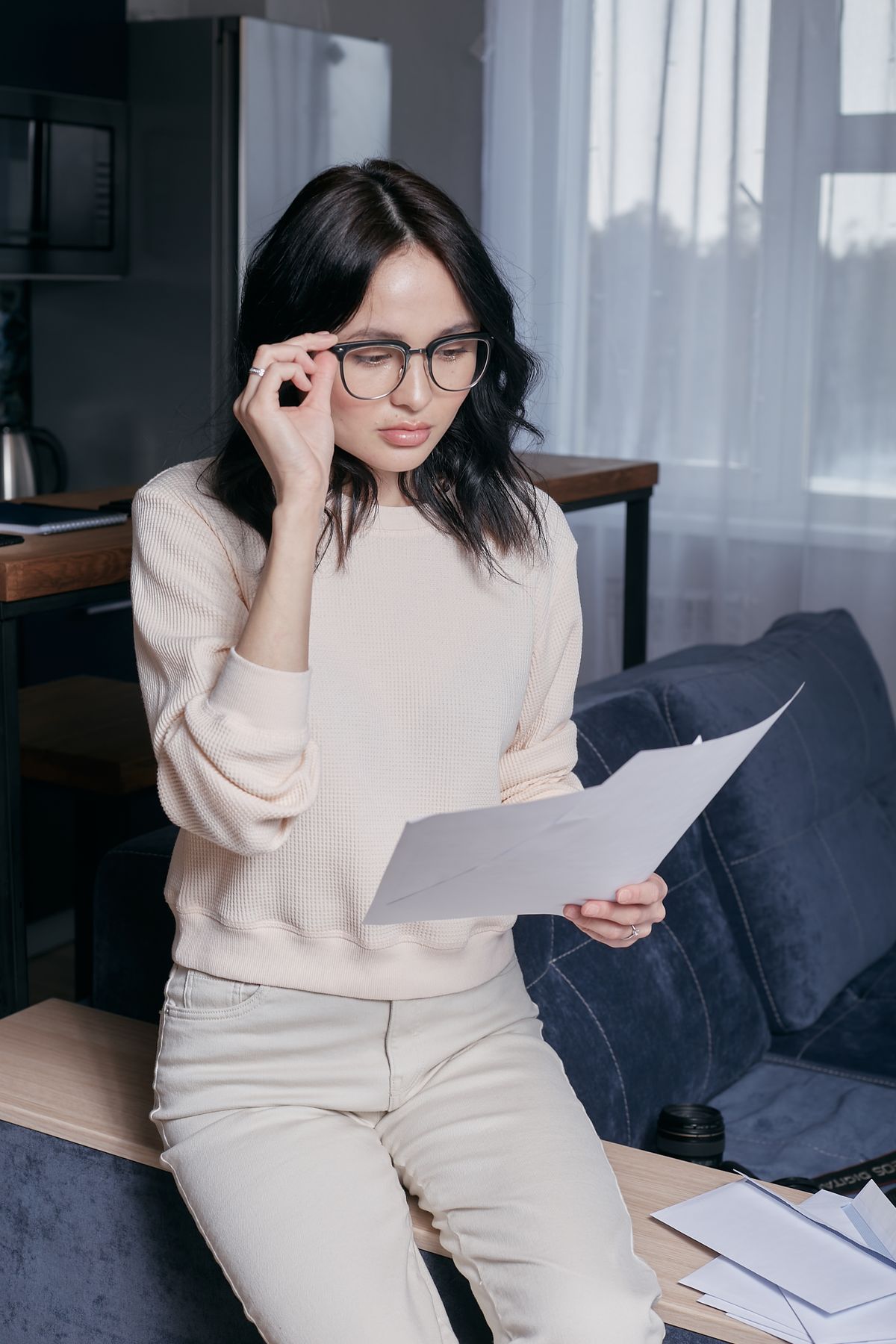 Person reviewing a will and financial documents at home