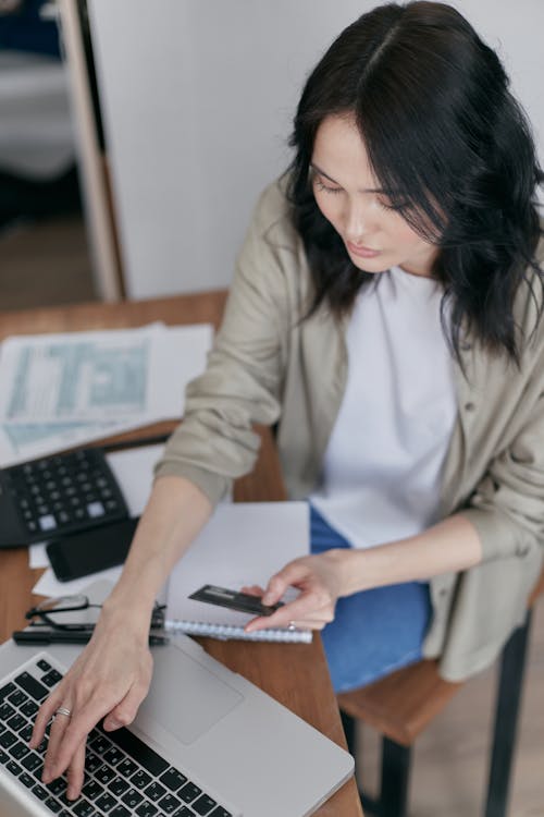 Woman Typing on a Laptop