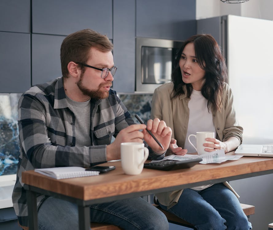 Free A Husband and Wife Having a Conversation about Finances at Home Stock Photo