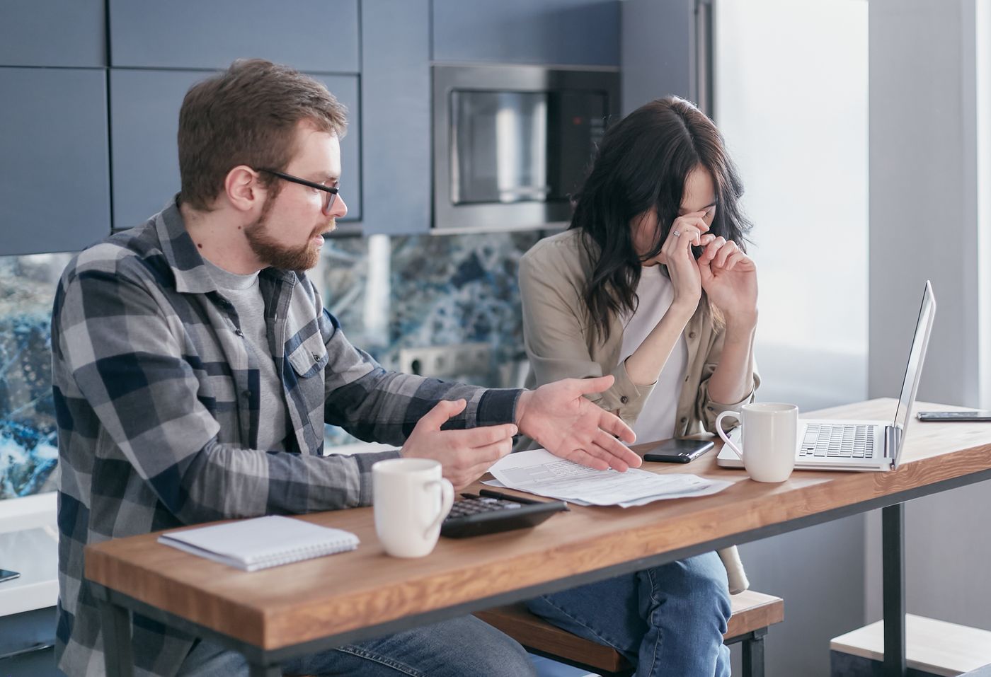 Couple discussing financial stress at a table
