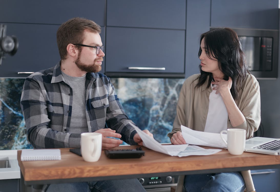 Free Man and Woman Sitting at Table Stock Photo