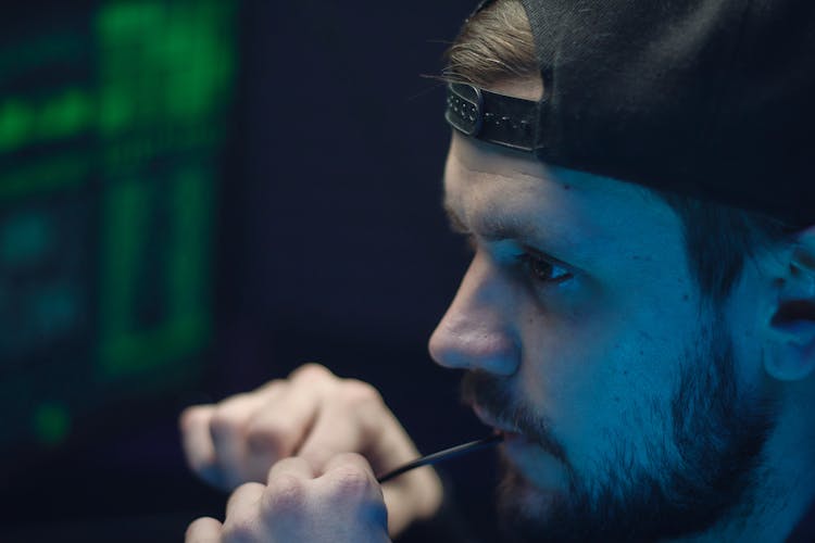 A Bearded Man Biting A Wire In Close-up Shot