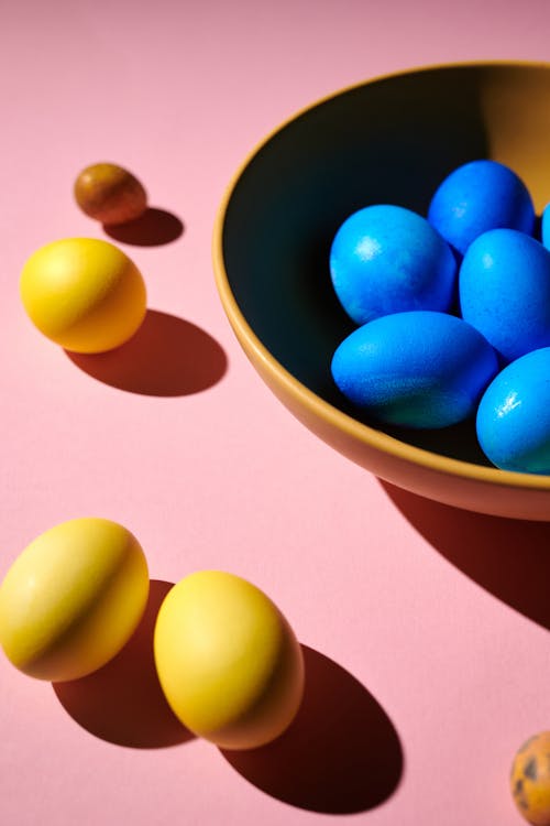 Free Blue and Yellow Egg on Blue Ceramic Bowl Stock Photo