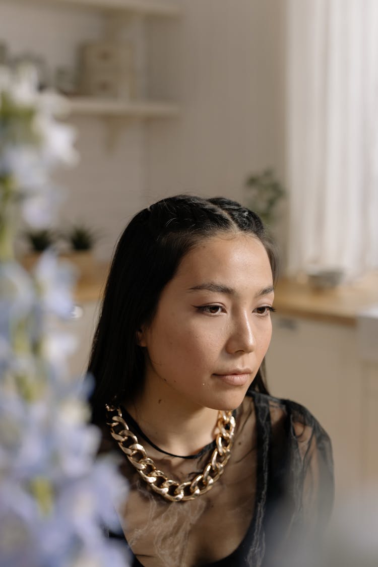 Woman In Black Blouse Wearing Gold Chain Necklace