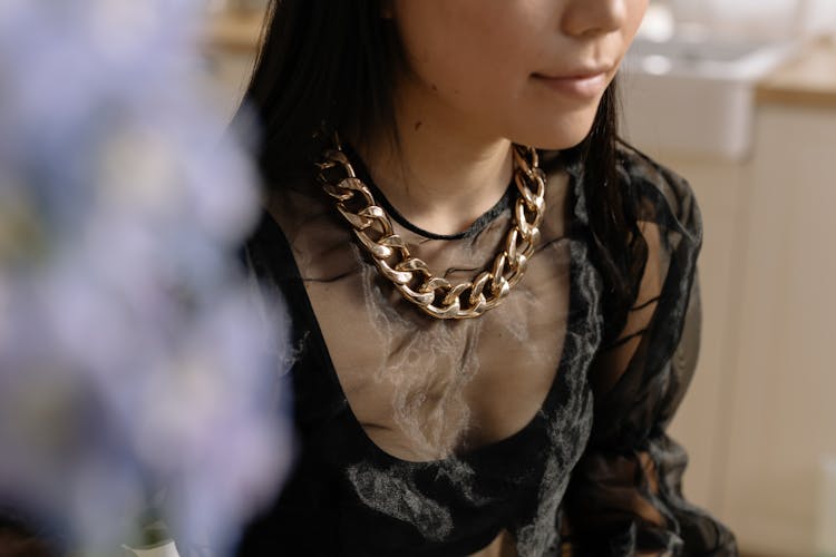 Woman In Black Top Wearing A Chain Necklace