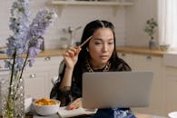 Woman in Black Shirt Using Macbook