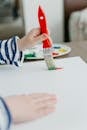 A Child Painting using a Paintbrush