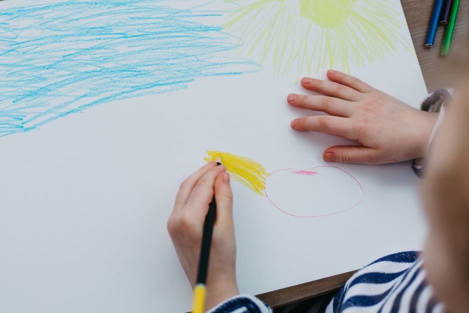 A child's drawing of a sun and house