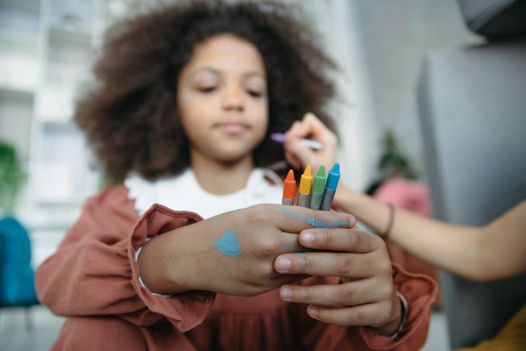 Girl Holding Crayons