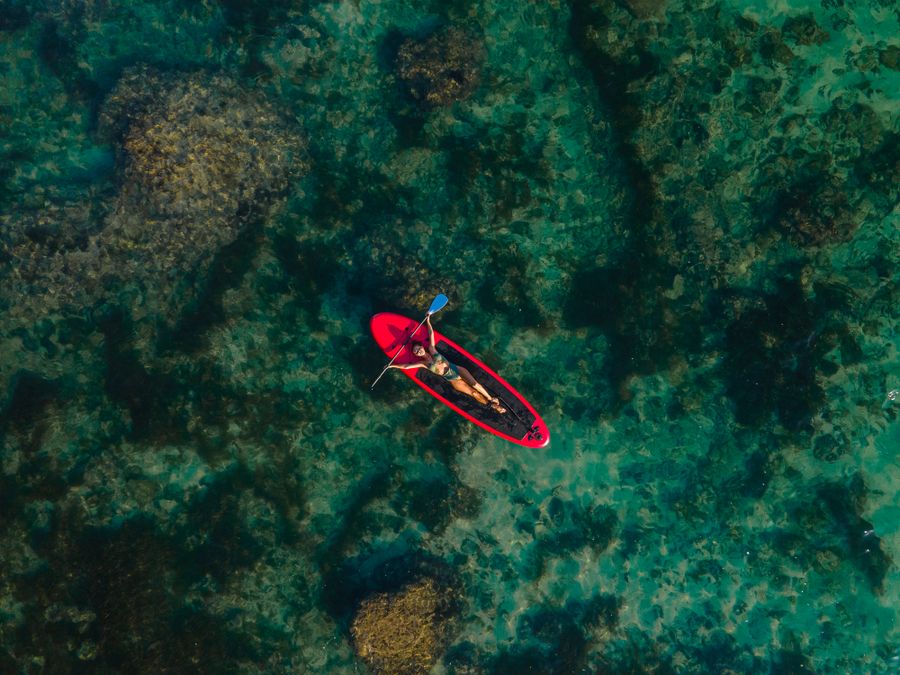 A paddleboard on the glassy morning water