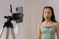 Selective Focus Photo of a Cellphone in a Tripod