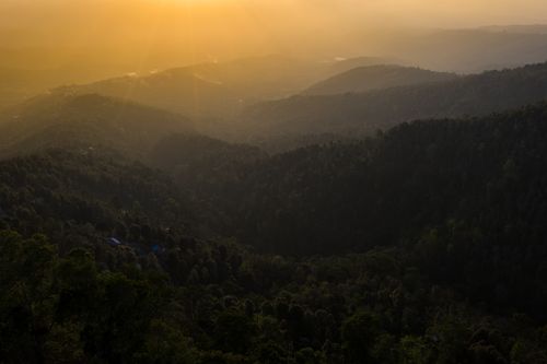 Free Breathtaking view of sunlit mountains during sunset, capturing the vast landscape. Stock Photo