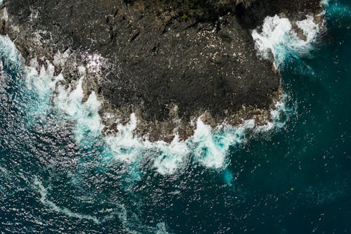 Aerial Shot of Waves Crashing on a Coast