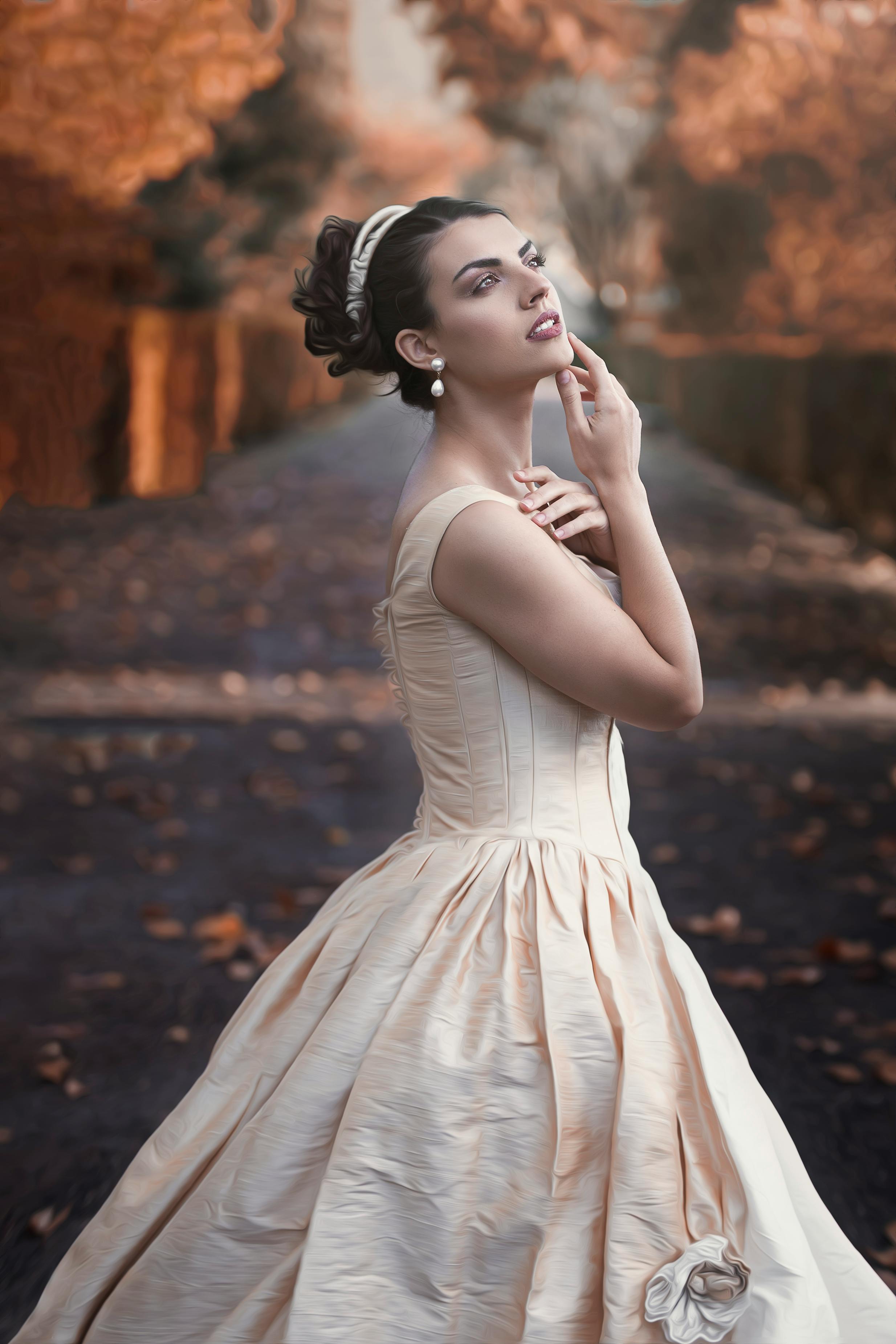 Beautiful bride posing in an elegant gown amidst a stunning autumn setting in Lisbon.