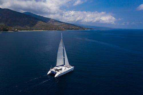 A Yacht Sailing in the Blue Ocean