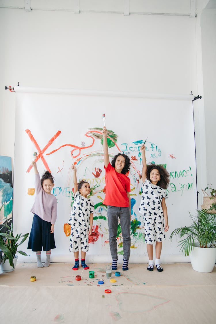 Kids Holding Paintbrushes