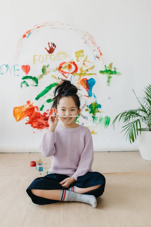 Girl Holding a Paintbrush