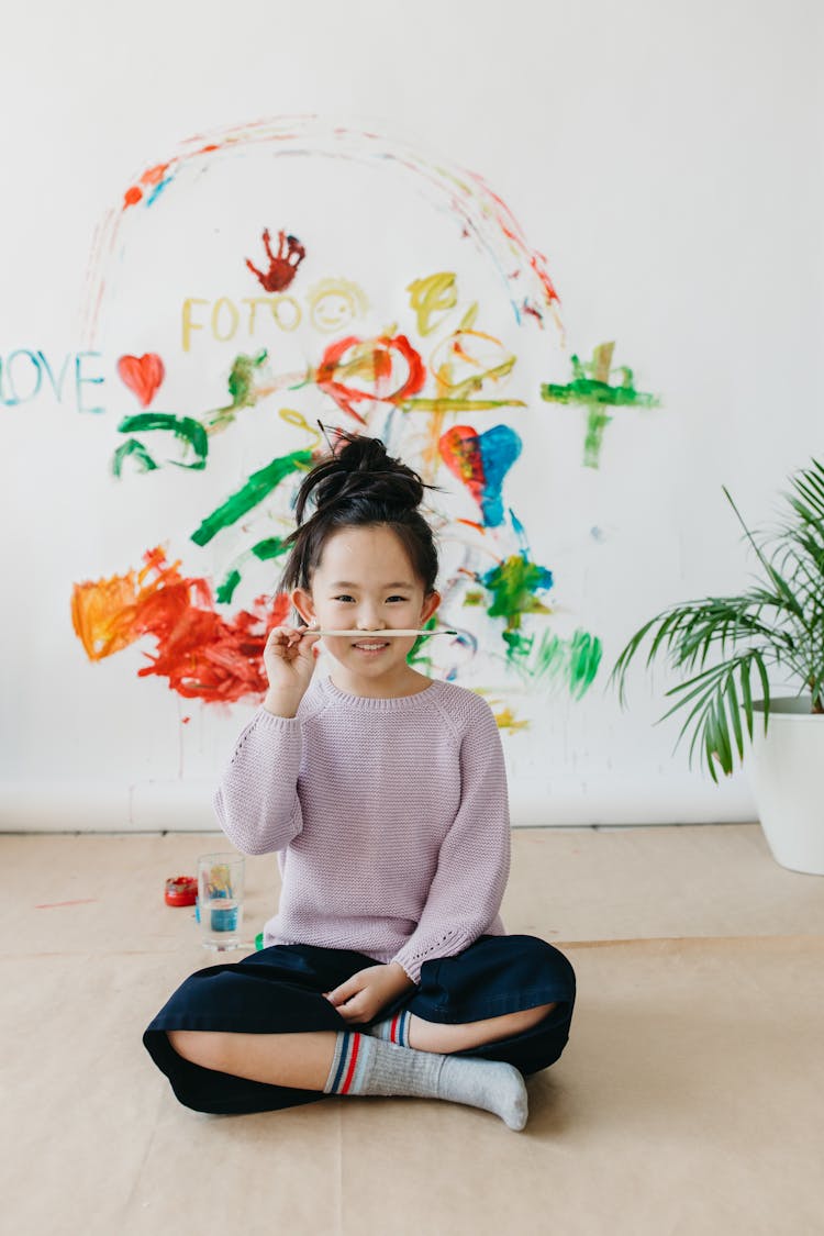 Girl Holding A Paintbrush