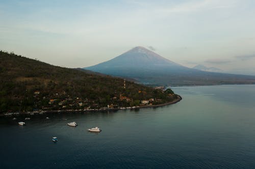 Free An Aerial Shot of a Shore with a View of a Volcano Stock Photo