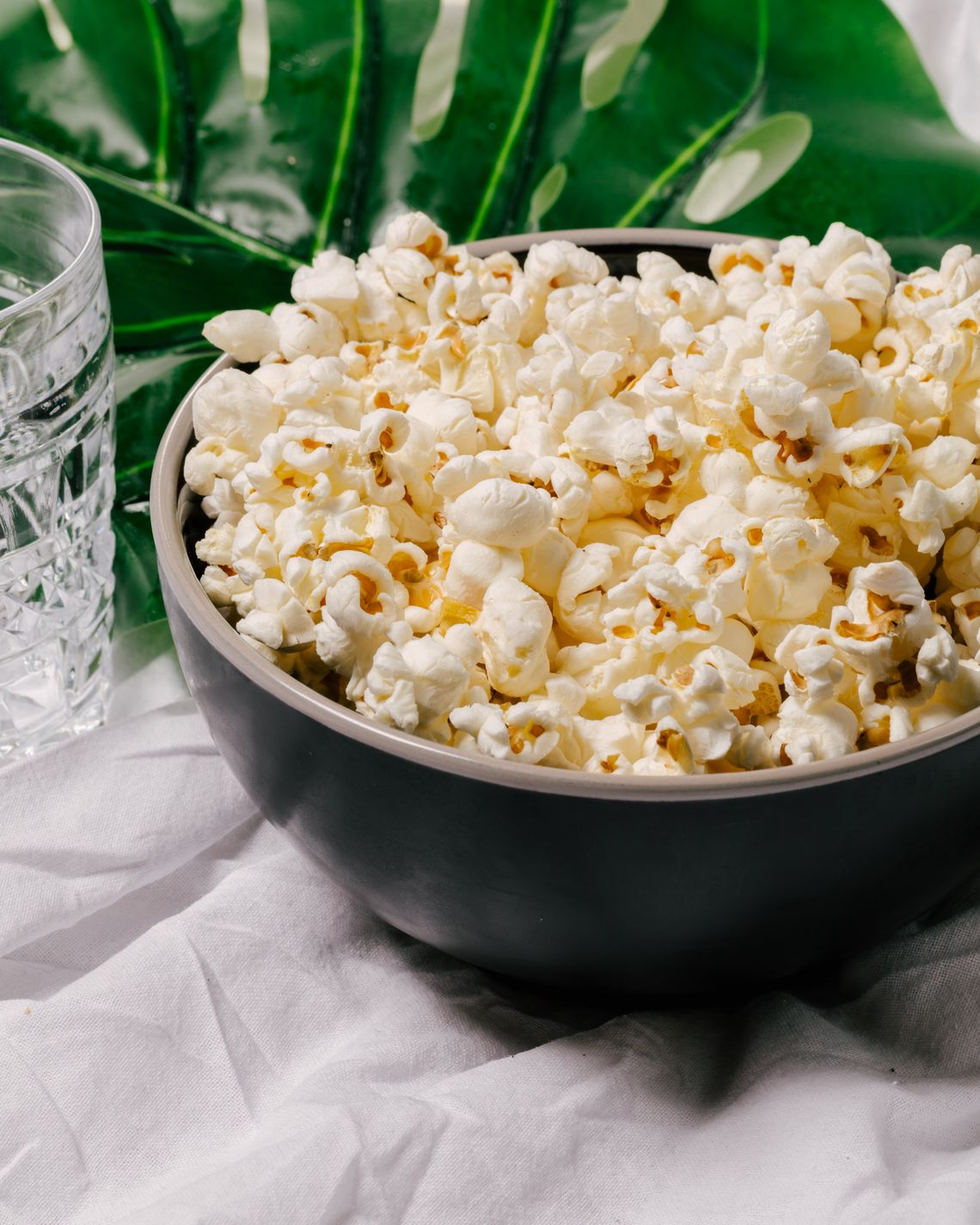 Freshly popped popcorn in a bowl on a softly styled tabletop.