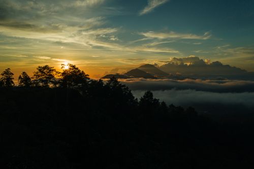 Free Breathtaking sunrise view over misty mountains and dense forest. Stock Photo