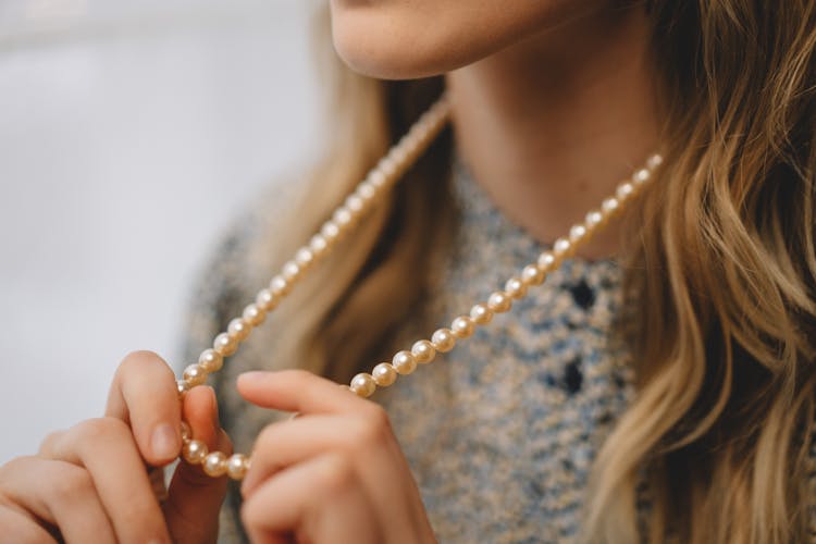 A Woman Wearing Pearl Necklace