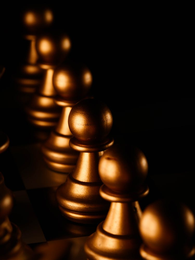 Gold Chess Piece On Black Surface