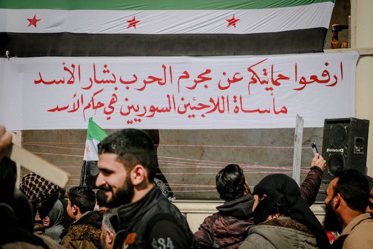 Unrecognizable Arab Protesters Against National Flag During Rally