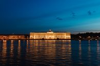 White Concrete Building Near Body of Water during Night Time