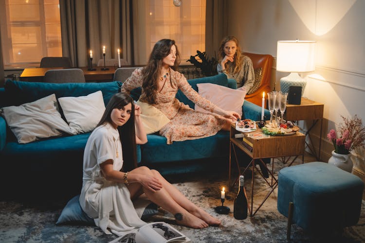 Women Wearing Dresses Enjoying Ladies Party With Candlelights And Snacks