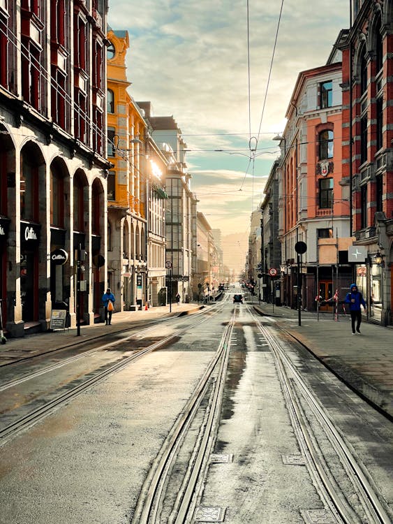 People Walking on Street Between Buildings