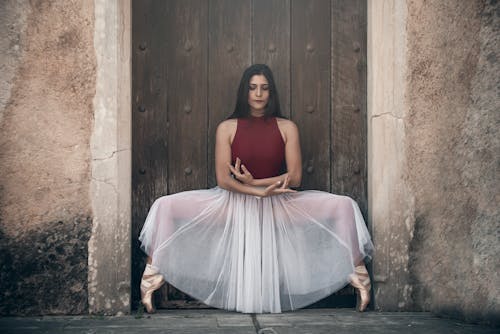 Free Woman in Red Tank Top Doing a Ballet Pose Stock Photo