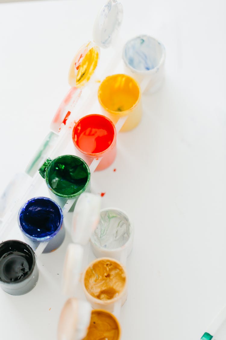 Assorted Paints On Round Containers