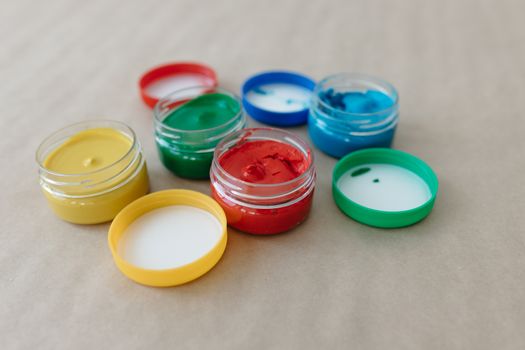 Vibrant paint jars with primary colors for art and creativity. Perfect for painting classes.
